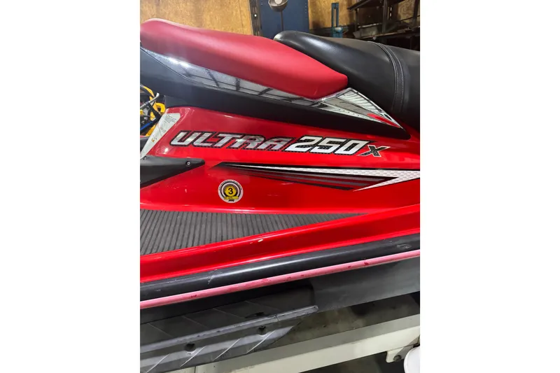 Slide: The Image of Red 2007 Kawasaki Jet Ski Ultra 250X with sleek design and bold graphics. - 3