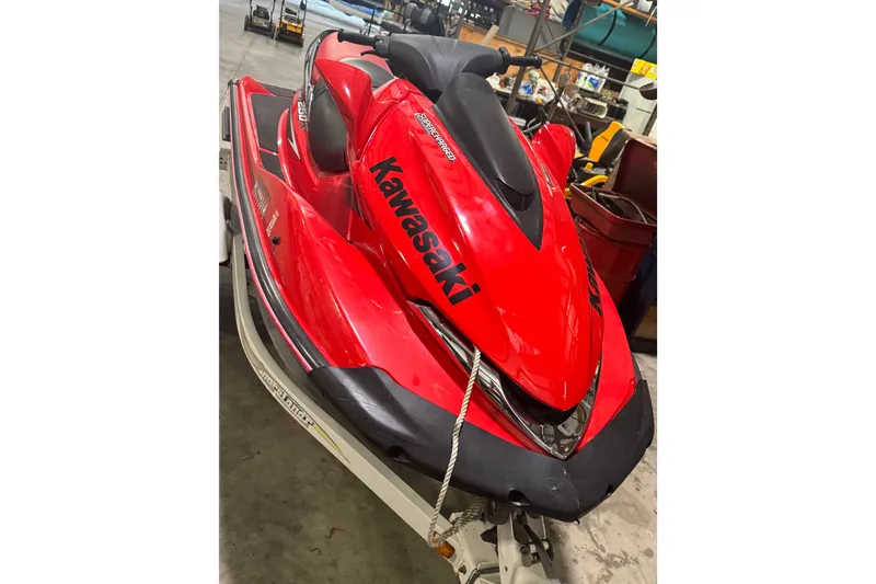Slide: The Image of Red 2007 Kawasaki Jet Ski Ultra 250X in a garage setting. - 2