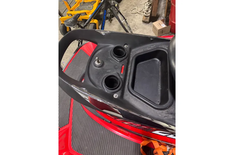 Slide: The Image of 2007 Kawasaki Jet Ski Ultra 250X dashboard with storage compartments in a garage setting. - 6