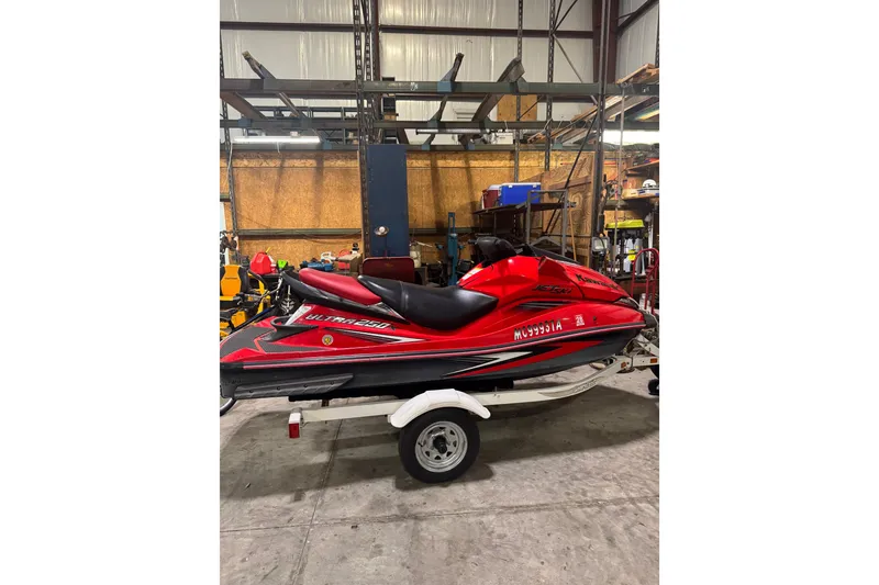Slide: The Image of 2007 Kawasaki Jet Ski Ultra 250X in a garage setting, red and black design. - 1