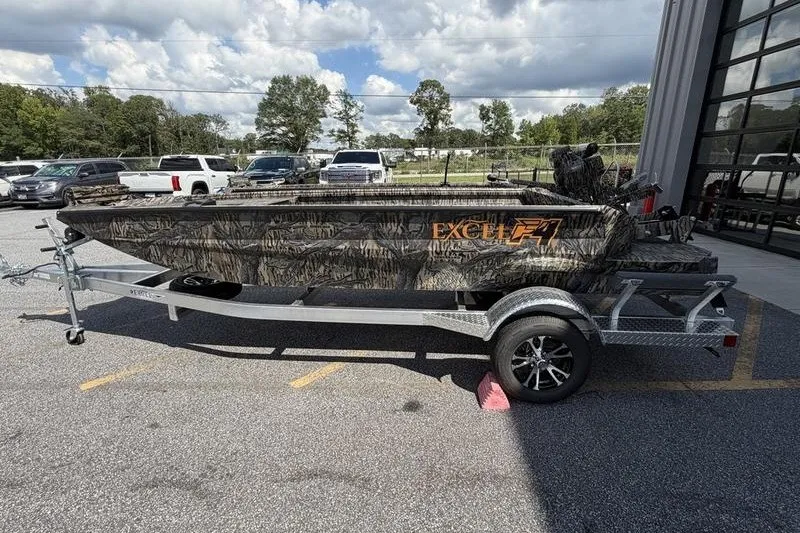 Slide: The Image of 2027 Excel 1751 Viper F4 boat on trailer, camo design, parked outdoors. - 4