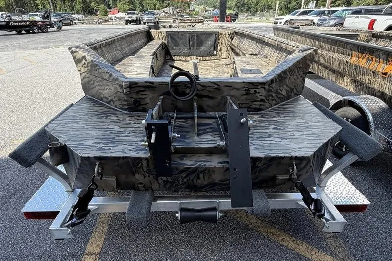 Slide: The Image of 2027 Excel 1751 Viper F4 boat on trailer, camo design, parked outdoors. - 2