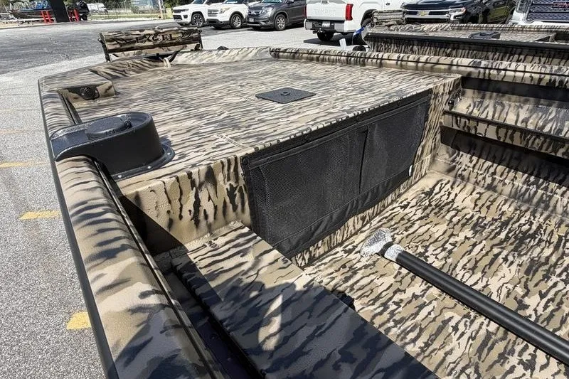 Slide: The Image of 2027 Excel 1751 Viper F4 boat with camouflage design, parked outdoors. - 7
