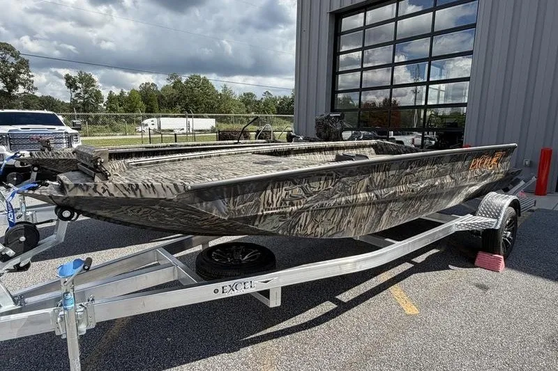 Slide: The Image of 2027 Excel 1751 Viper F4 boat on trailer, camo design, parked outdoors. - 22