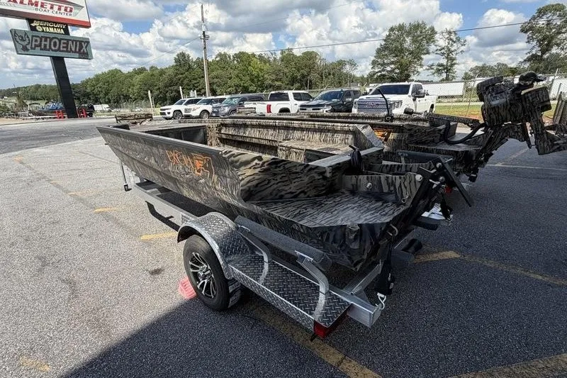 Slide: The Image of 2027 Excel 1751 Viper F4 boat on trailer, parked outdoors, with camo design. - 16