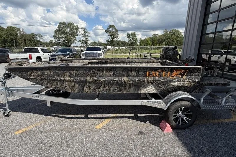Slide: The Image of 2027 Excel 1751 Viper F4 boat with camouflage design on a trailer, parked outdoors. - 17