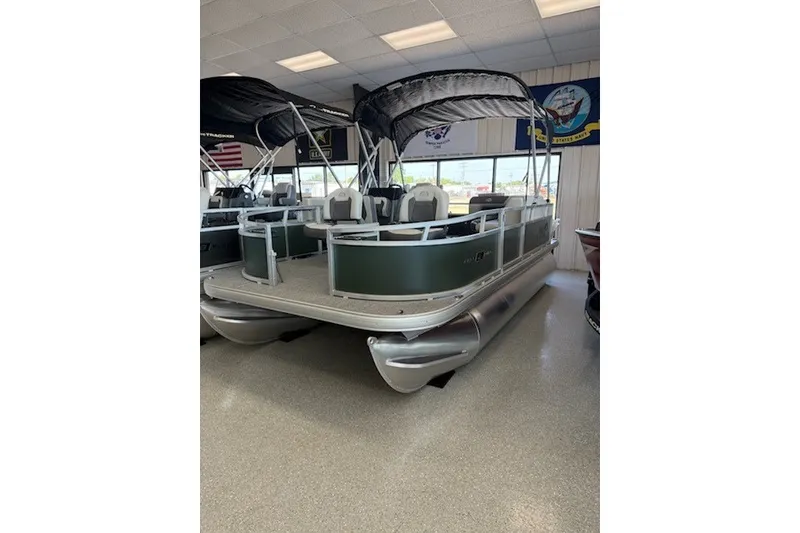 The Image of 2027 Sun Tracker Bass Buggy 16 XL Select pontoon boat displayed indoors. - 1