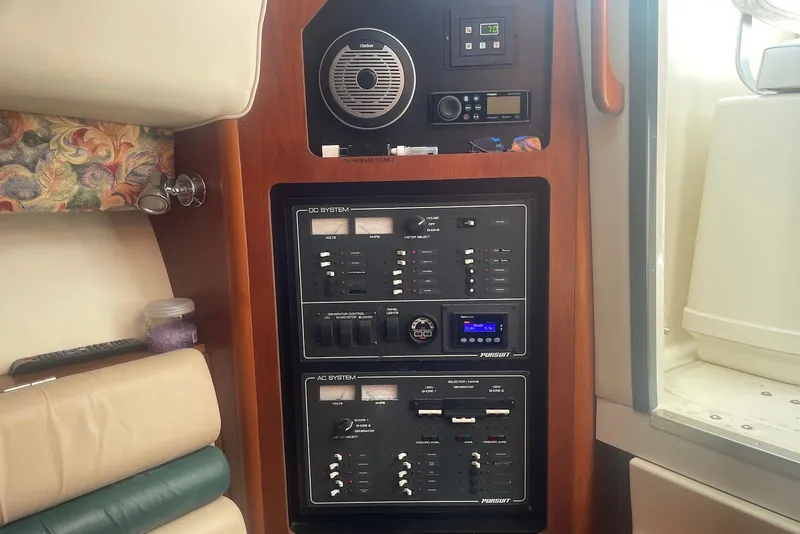 Slide: The Image of Control panel of a 1997 Pursuit 3400 Express boat, featuring DC and AC systems. - 14