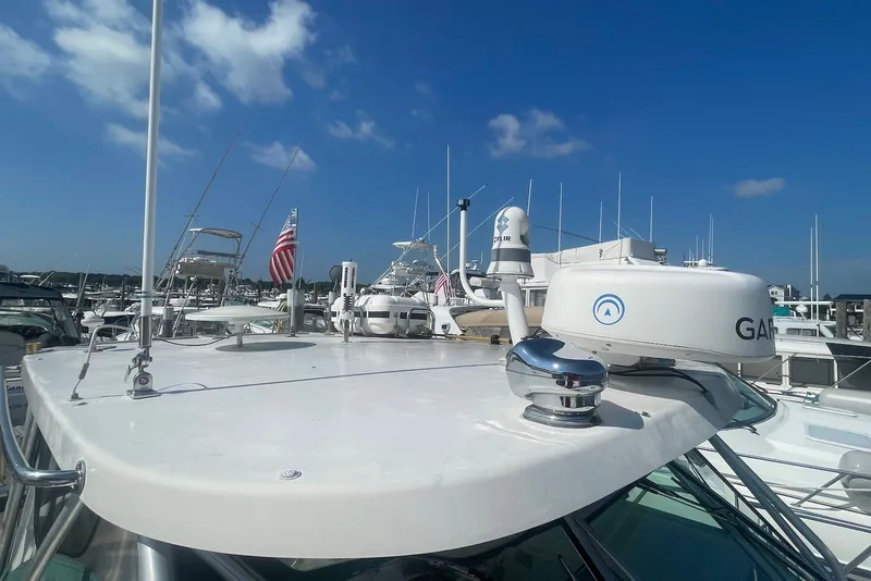 Slide: The Image of 1997 Pursuit 3400 Express boat docked at marina under clear blue sky. - 7