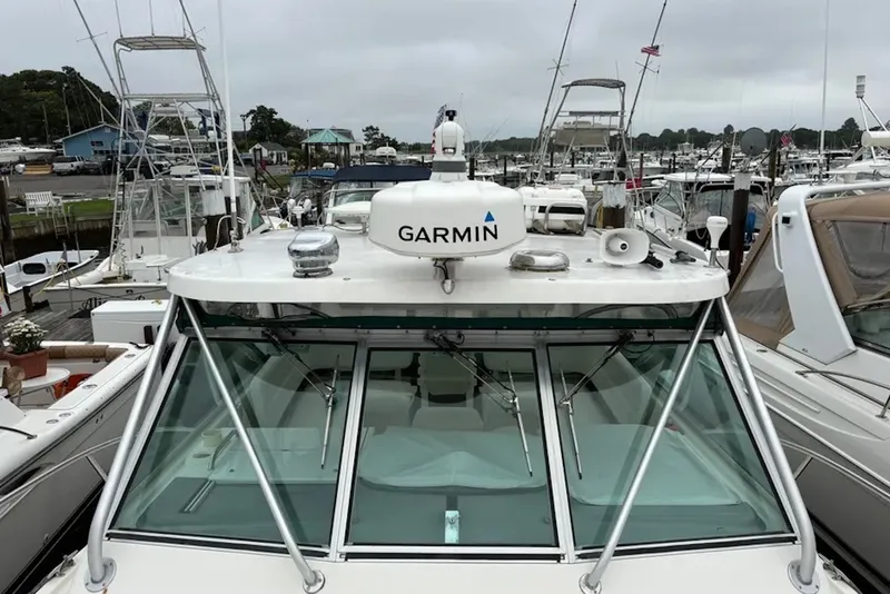 Slide: The Image of 1997 Pursuit 3400 Express boat with Garmin equipment docked in a marina. - 5