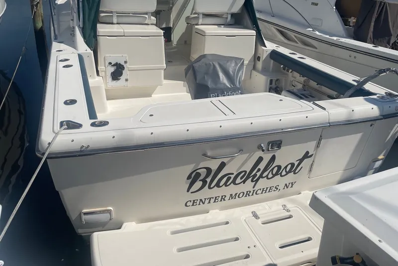 Slide: The Image of 1997 Pursuit 3400 Express boat docked, named "Blackfoot," located in Center Moriches, NY. - 3