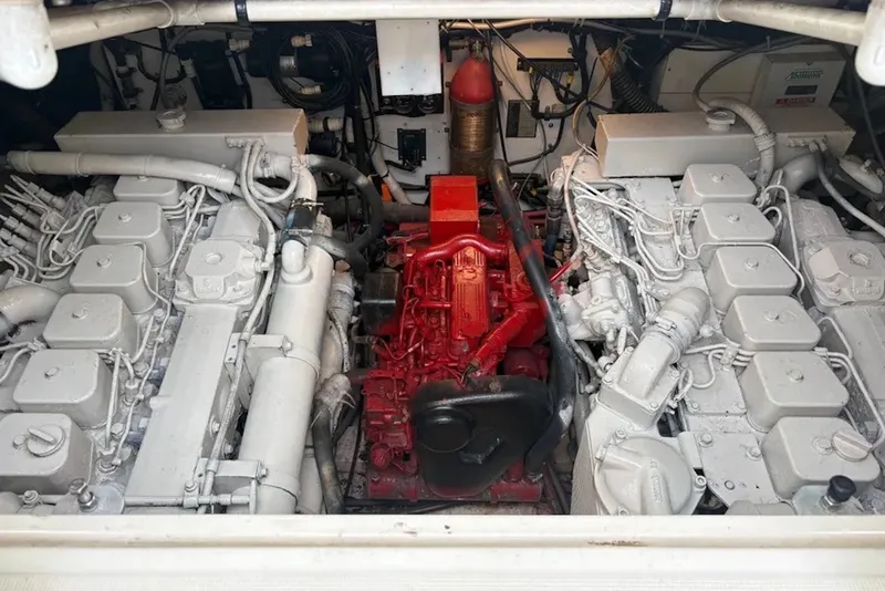 Slide: The Image of Engine room of a 1997 Pursuit 3400 Express boat, showcasing dual engines and mechanical components. - 23