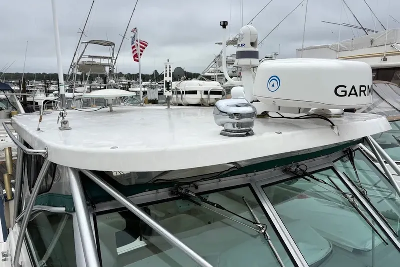 Slide: The Image of 1997 Pursuit 3400 Express boat with Garmin radar, docked in a marina. - 6