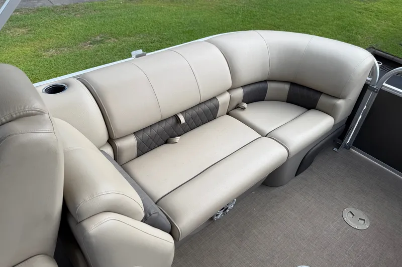 Slide: The Image of 2023 Sun Tracker Party Barge 22 XP3 interior seating with beige upholstery and cup holder. - 19