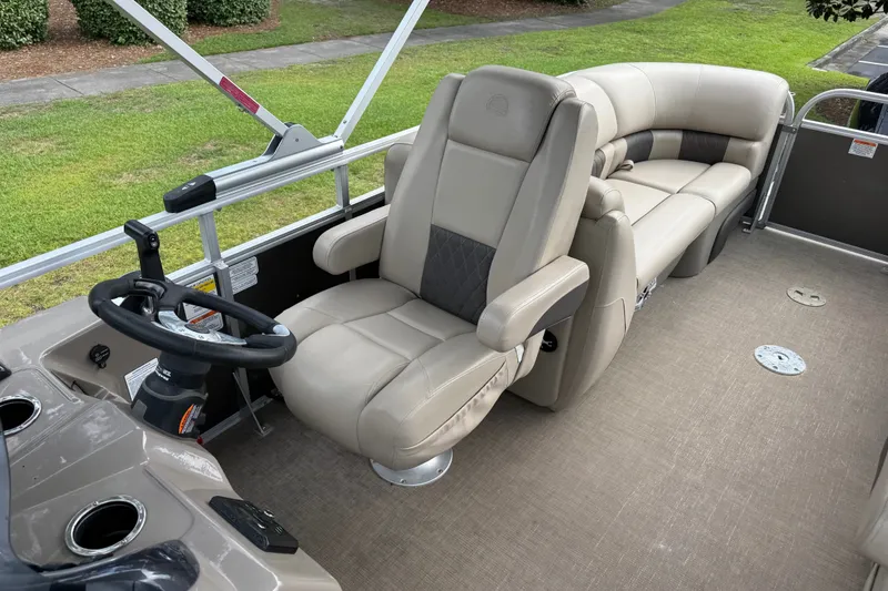 Slide: The Image of 2023 Sun Tracker Party Barge 22 XP3 interior with plush seating and steering console. - 17