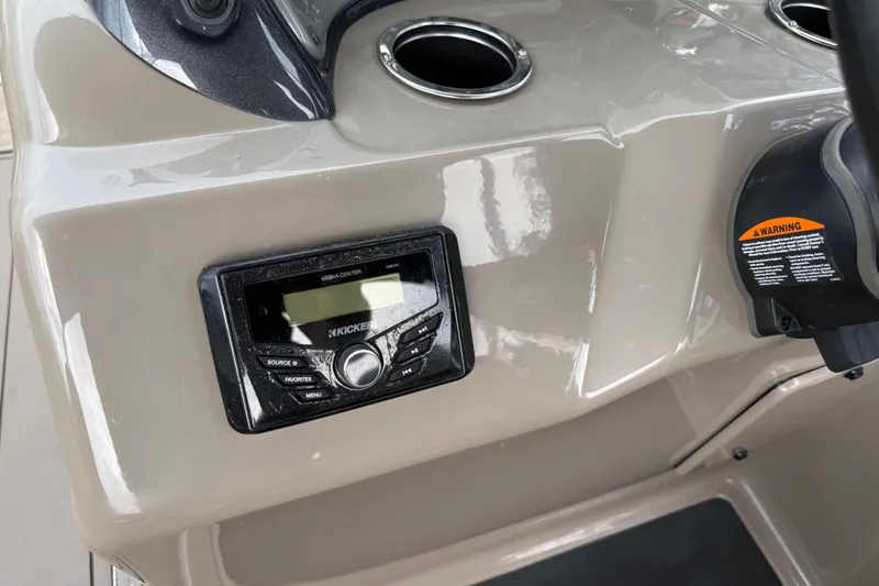 Slide: The Image of 2023 Sun Tracker Party Barge 22 XP3 dashboard with Kicker media center and cup holders. - 26