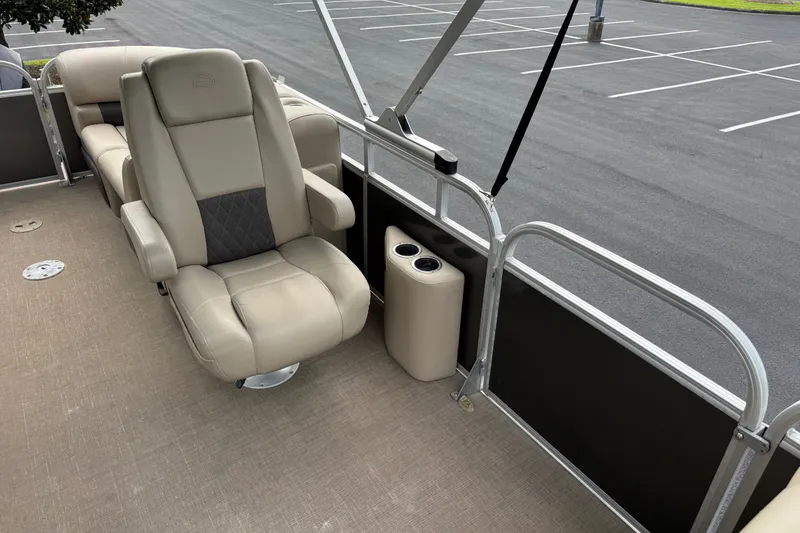 Slide: The Image of 2023 Sun Tracker Party Barge 22 XP3 interior with beige seating and cup holders. - 16