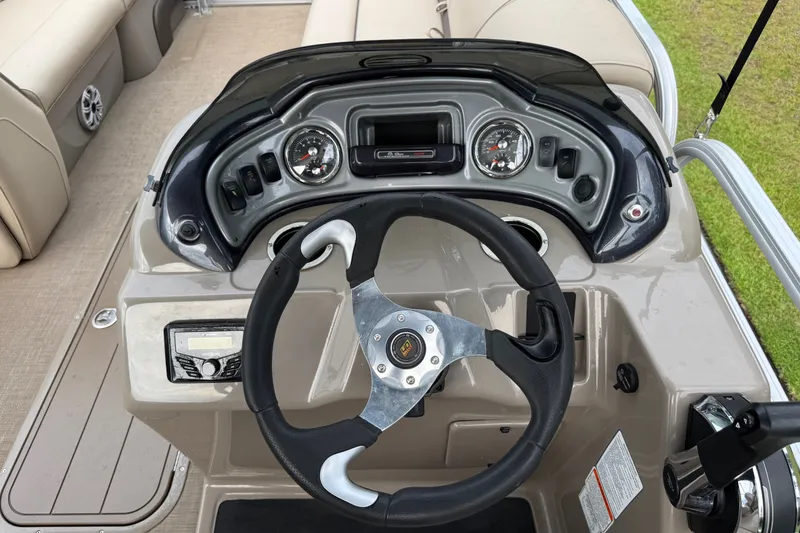 Slide: The Image of 2023 Sun Tracker Party Barge 22 XP3 dashboard with steering wheel and controls. - 25