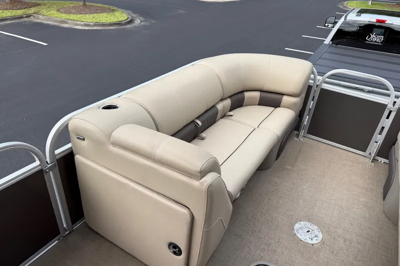 Slide: The Image of 2023 Sun Tracker Party Barge 22 XP3 interior with beige seating and cup holder. - 29
