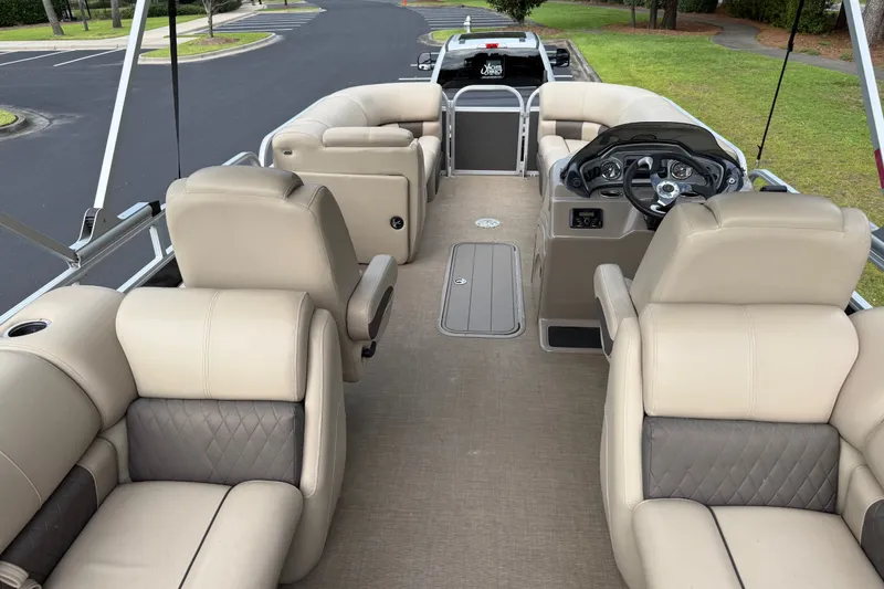 Slide: The Image of 2023 Sun Tracker Party Barge 22 XP3 interior with beige seating and steering console. - 24