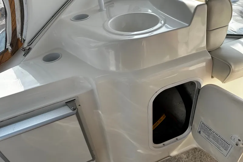 Slide: The Image of Interior view of a 1997 Cruisers Yachts 337 Esprit, featuring a sink and storage compartment. - 6