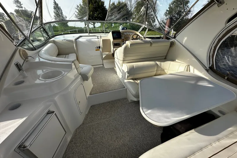 Slide: The Image of 1997 Cruisers Yachts 337 Esprit interior with seating, table, and helm. - 2