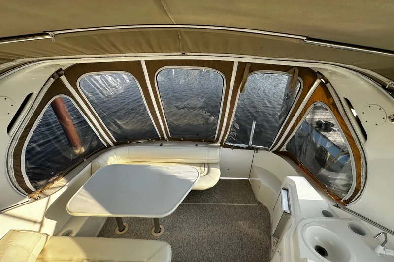 Slide: The Image of Interior of 1997 Cruisers Yachts 337 Esprit with seating, table, and windows overlooking water. - 1