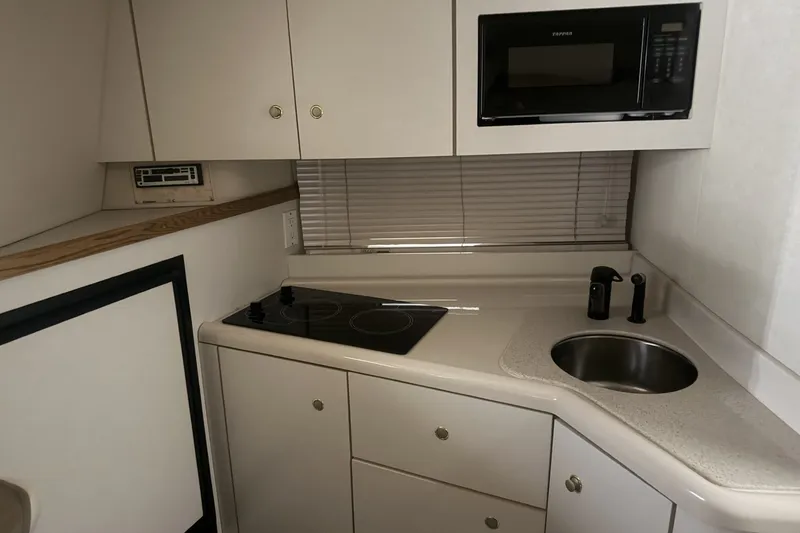 Slide: The Image of 1997 Cruisers Yachts 337 Esprit kitchen with stove, sink, and microwave. - 17