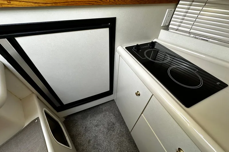Slide: The Image of 1997 Cruisers Yachts 337 Esprit kitchen with stove and refrigerator. - 20