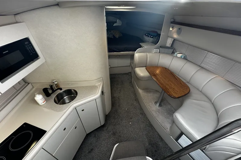 Slide: The Image of Interior of 1997 Cruisers Yachts 337 Esprit with kitchenette and seating area. - 13