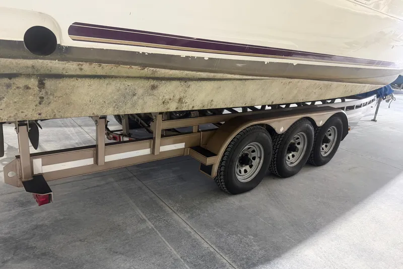 Slide: The Image of 1997 Cruisers Yachts 337 Esprit on a triple-axle trailer, showing hull and wheels. - 26