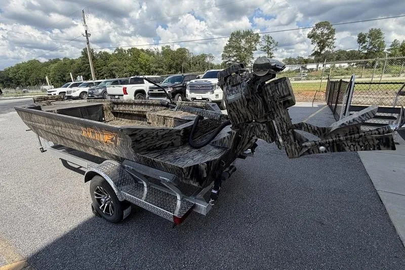 Slide: The Image of 2027 Excel 1754 Shallow Water F4 boat on trailer, parked outdoors under cloudy sky. - 15
