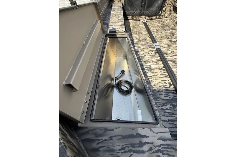 Slide: The Image of 2027 Excel 1754 Shallow Water F4 boat interior with open storage compartment. - 14