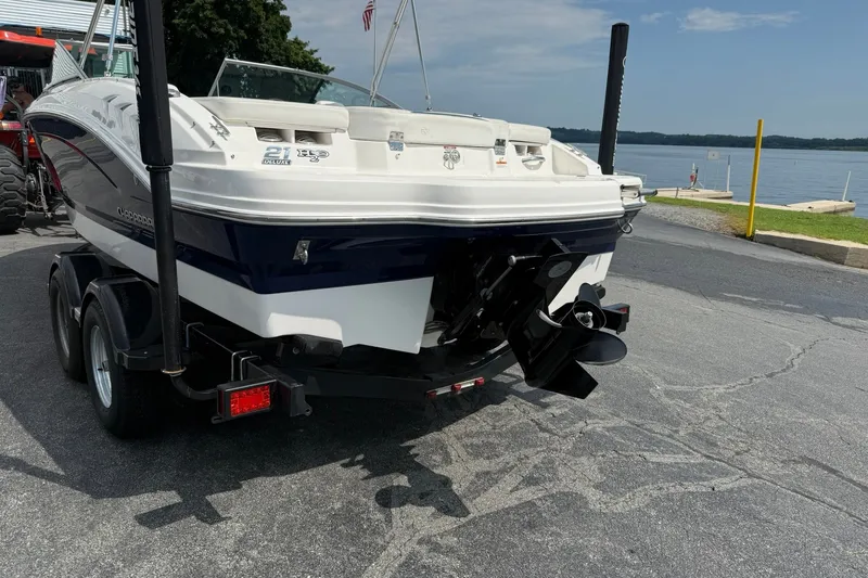 Slide: The Image of 2014 Chaparral 21 H2O Sport boat on trailer near a lake. - 3