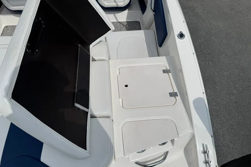 Slide: The Image of 2014 Chaparral 21 H2O Sport boat interior with open storage compartment. - 9