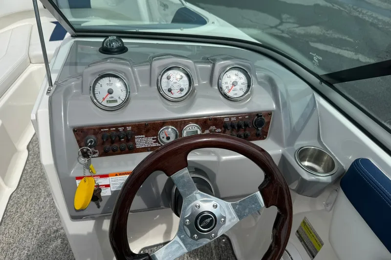 Slide: The Image of Dashboard of 2014 Chaparral 21 H2O Sport boat with gauges and steering wheel. - 16