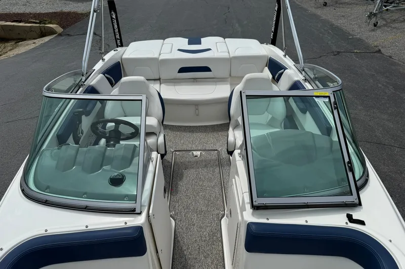 Slide: The Image of 2014 Chaparral 21 H2O Sport boat interior with seating and steering wheel. - 22