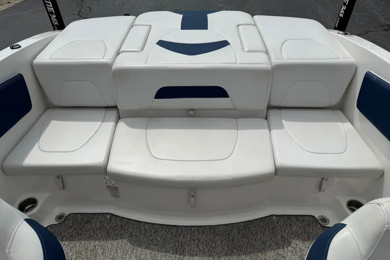 Slide: The Image of 2014 Chaparral 21 H2O Sport boat interior with white and blue seating. - 12