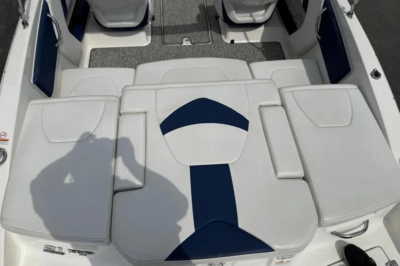 Slide: The Image of 2014 Chaparral 21 H2O Sport boat interior with white and blue seating. - 7