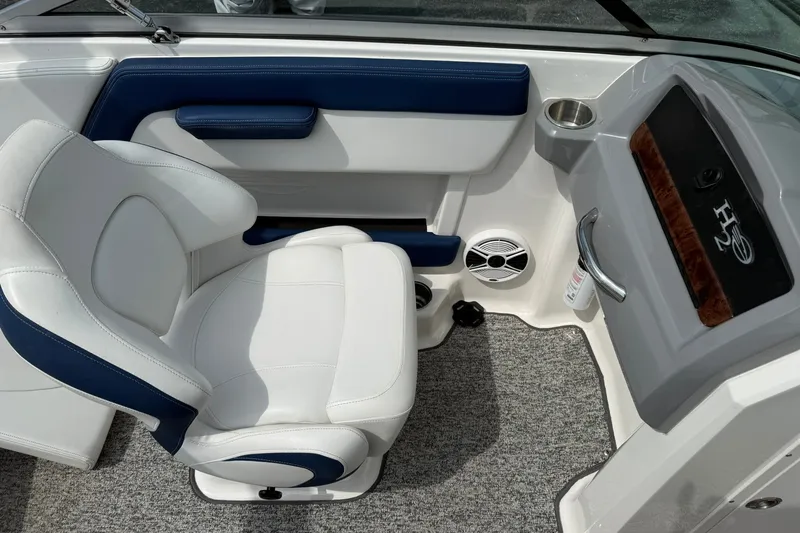 Slide: The Image of 2014 Chaparral 21 H2O Sport boat interior with white and blue seating. - 18