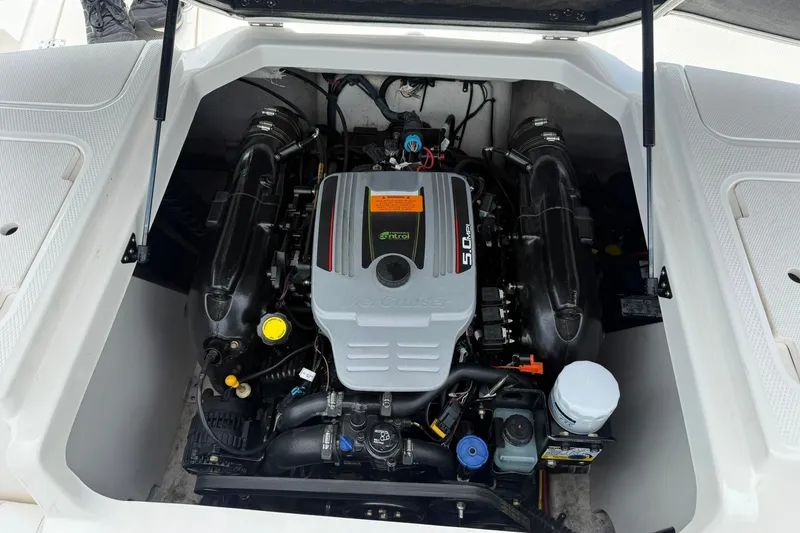 Slide: The Image of 2014 Chaparral 21 H2O Sport boat engine compartment, featuring a powerful 5.0L engine. - 13