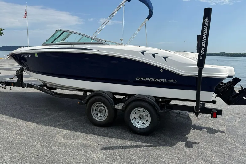 Slide: The Image of 2014 Chaparral 21 H2O Sport boat on trailer by waterfront. - 2