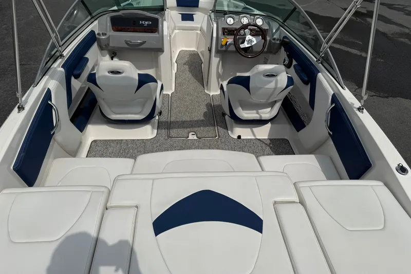 Slide: The Image of 2014 Chaparral 21 H2O Sport boat interior with white and blue seating. - 8