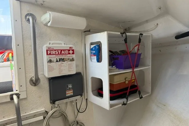 Slide: The Image of Interior of 2002 Island Hopper Forward Cabin with first aid kit and storage shelves. - 10