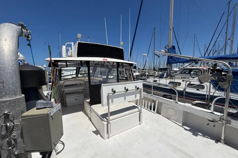 Slide: The Image of 2002 Island Hopper Forward Cabin boat docked at marina under clear blue sky. - 13