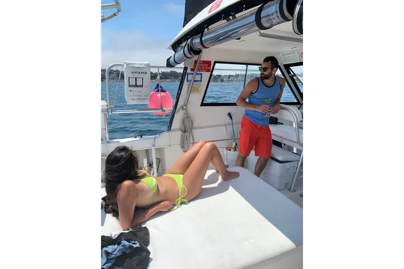 Slide: The Image of Two people relaxing on a boat with a view of the water. - 17