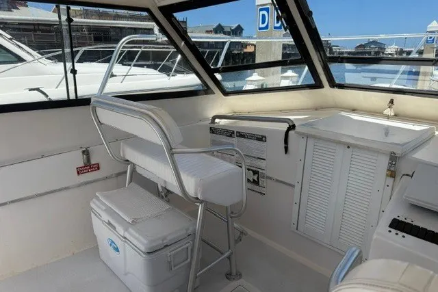 Slide: The Image of 2002 Island Hopper Forward Cabin interior with seating and storage, docked at marina. - 8