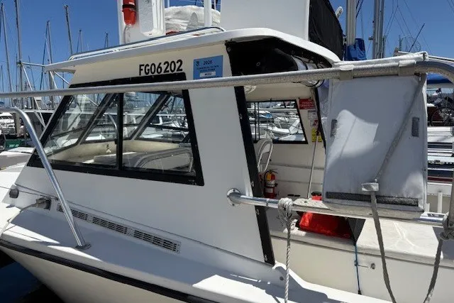 Slide: The Image of Island Hopper Forward Cabin 2002 boat docked at marina, featuring sleek design and spacious cabin. - 9