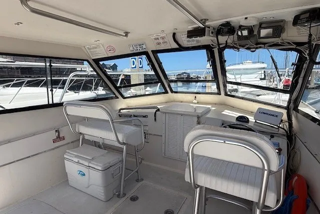 Slide: The Image of Interior of a 2002 Island Hopper Forward Cabin boat, featuring helm and seating area. - 12