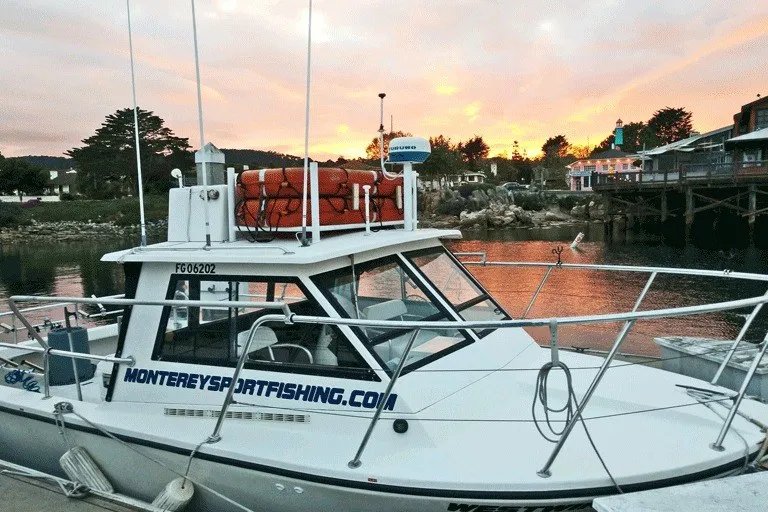Slide: The Image of Island Hopper Forward Cabin 2002 boat docked at sunset, featuring Monterey Sportfishing branding. - 16